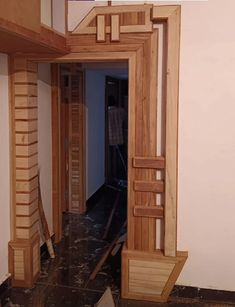 an open doorway with wooden stairs leading to another room