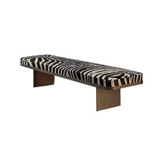 a zebra print bench sitting in front of a white wall