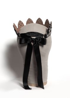 Dramatic leather tiara crown headpiece with stamped metal Fleur de Lis overlay attached with rivets. Fastens in back with satin ribbons. Available in leather, PVC, and vegan leather. Shown in black Horween Chromexcel leather (product shot) and oxblood leather (on model). Silver toned nickel plated steel hardware. SMALL/MEDIUM fits 20-23" head size.MEDIUM/LARGE fits 22-25" head size.Custom sizing available. Editorial photos by Chris Whitmore/Elden Images // Models: Michelle and Karina. All pieces Goth Tiara, Anastasia Crown, Drag Party, Krishna Dress, Horween Chromexcel, Crown Headpiece, Leather Designs, Oxblood Leather, Stamped Metal