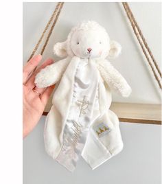 a white teddy bear hanging from a rope