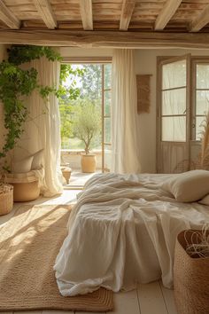 a bed with white sheets and pillows in a bedroom next to a large open window