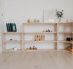 an empty shelf in the corner of a room with toys and books on top of it