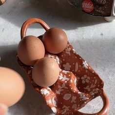 an egg carton with three eggs in it