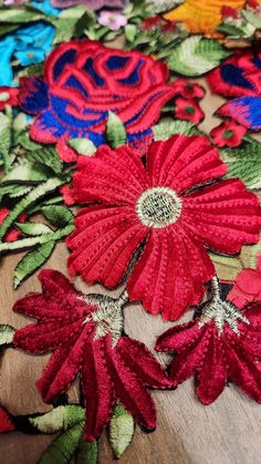 red and blue flowers on a wooden surface