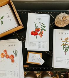 several calendars are sitting on a table next to some shoes and other items that have been placed around them