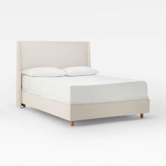 a bed with white sheets and pillows on it's headboard, against a white background