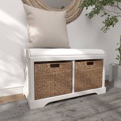 a white bench with two wicker baskets on it next to a potted plant