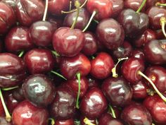 a pile of cherries sitting on top of each other