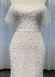 the back of a white wedding dress on display