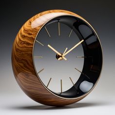 a wooden clock with black and gold accents