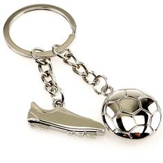 a soccer ball and shoe keychain on a white background