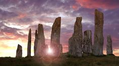 the sun is setting over stonehenge in england