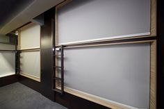 an empty walk in closet with white walls and wood trim on the doors, along with carpeted flooring