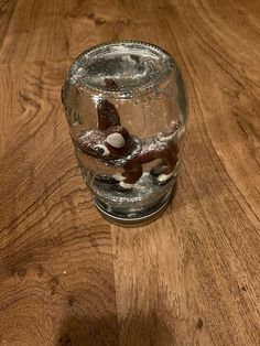 a glass with some water in it on a wooden table