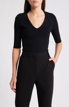 Build up your basics wardrobe with this V-neck top boasting raised seams at the shoulders for stylish flair. 23" length V-neck Elbow-length sleeves 63% viscose, 36% polyamide, 1% elastane Hand wash, dry flat Imported Modern V-neck Blouse For Fall, Black V-neck Top For Workwear In Fall, Black V-neck Top For Fall Workwear, Elegant Solid Color V-neck Knit Top, Fine Knit V-neck Top For Work, Classic Structured Formal Tops, Elegant Fitted Knit Top For Workwear, Elegant Fitted Knit Top, Elegant V-neck Top For Business Casual