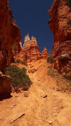 a dirt path in the middle of some rocks