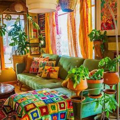 a living room filled with furniture and lots of plants