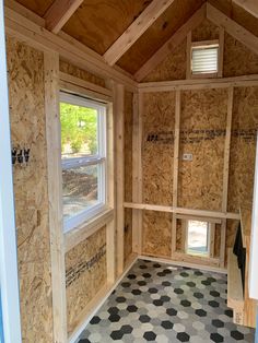 the inside of a house that is being built with plywood and tile flooring