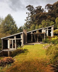 the house is surrounded by trees and grass