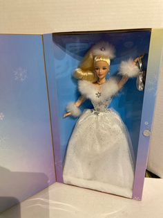 a barbie doll in a box with snowflakes