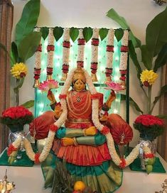 the statue is surrounded by flowers and candles