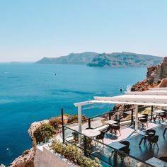 an outdoor dining area overlooking the ocean