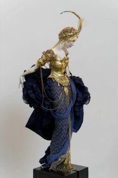 a statue of a woman in blue and gold