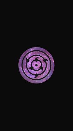 a purple and black circular object in the dark