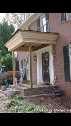 a house that is being remodeled with some tools on the front porch and steps leading up to it