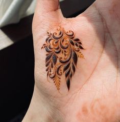 a woman's hand with a tattoo on it