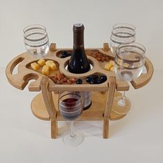 a wine bottle and glasses on a wooden tray