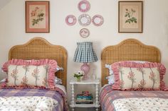 two twin beds in a bedroom with pink and blue bedding