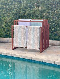 a towel rack next to a swimming pool