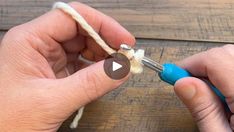 someone is cutting the end of a piece of yarn with scissors