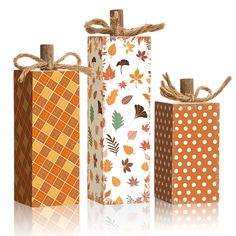 three boxes with different patterns and designs on them, one is tied to the side