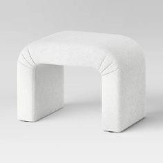 a white chair with a curved seat on it