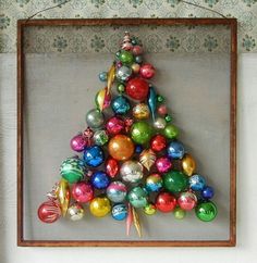 a christmas tree made out of ornaments in a frame