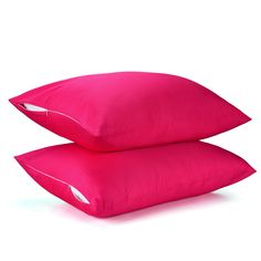 two bright pink pillows sitting next to each other