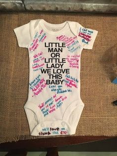 a baby's bodysuit with writing on it