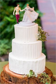 a wedding cake with two figurines on top