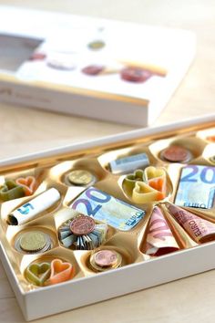 a white box filled with lots of different types of money