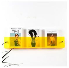 a yellow shelf with four different books on it and one is in the shape of a woman's head