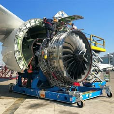 an airplane engine being worked on by workers