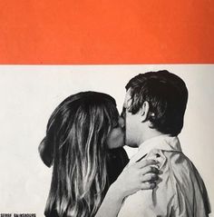 a man and woman kissing each other in front of an orange wall with white stripes