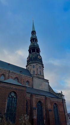 an old brick building with a steeple on top