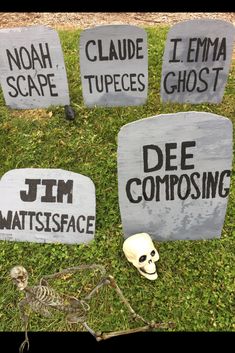 tombstones with names and skulls on them in the grass next to some fake human heads