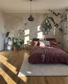 a bedroom with wooden floors and walls decorated in shades of pink, grey and white