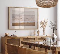 a dining room with wicker furniture and art on the wall