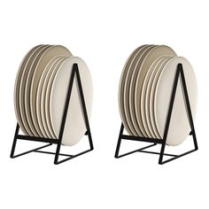 a stack of plates sitting next to each other on a metal stand with black legs