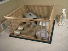 a dog is sitting on the floor next to a cage